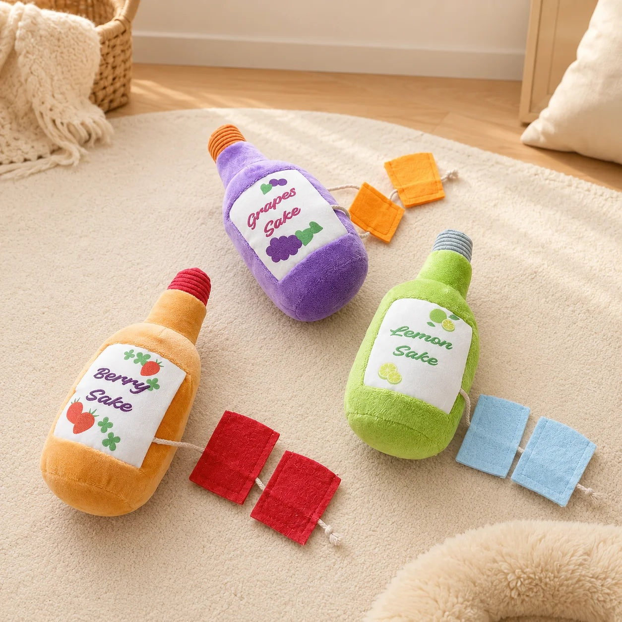 Three colorful plush sake bottle dog toys in purple, green, and orange with pull-out felt snuffle tabs on a rug.