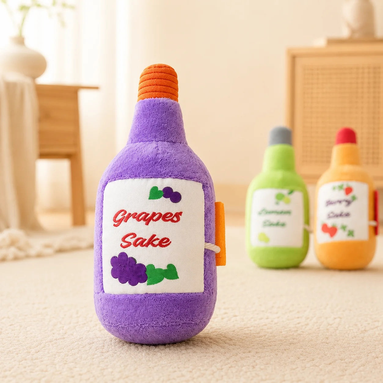 Close-up of a purple Grapes Sake plush squeaker dog toy with cute grape graphics standing upright on a soft rug.
