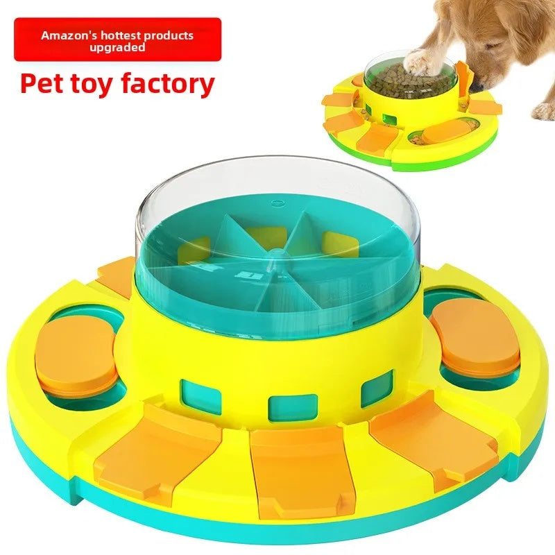 Close-up of the yellow and teal interactive dog slow feeder toy with orange sliding covers and a clear center dome.