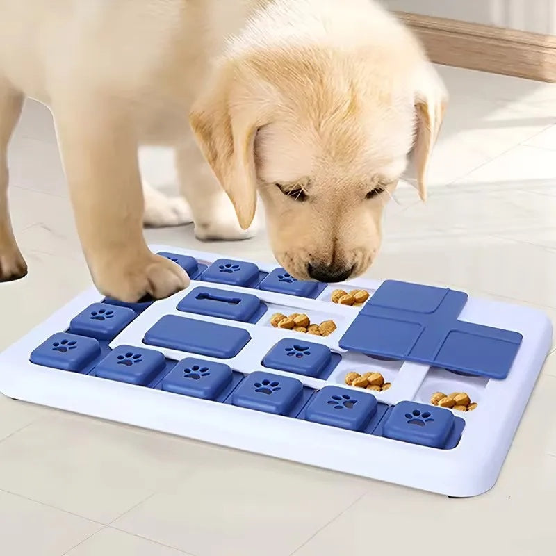 Close-up of a puppy using its nose and paws to slide the blue buttons on the smart interactive dog puzzle toy.