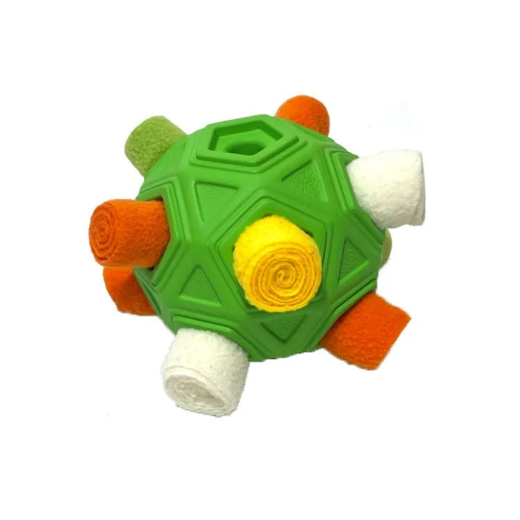 Green snuffle ball dog puzzle toy with white, orange, and yellow fleece strips tucked inside.