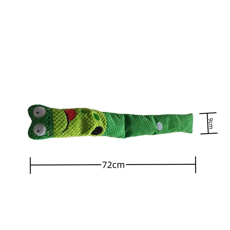 Green plush snuffle snail dog toy rolled up with a cute smiling face and red tongue.