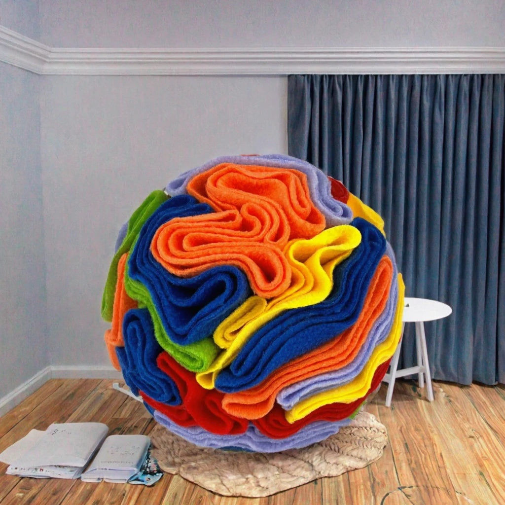 Vibrant rainbow fleece dog snuffle ball displayed in a modern cozy living room setting