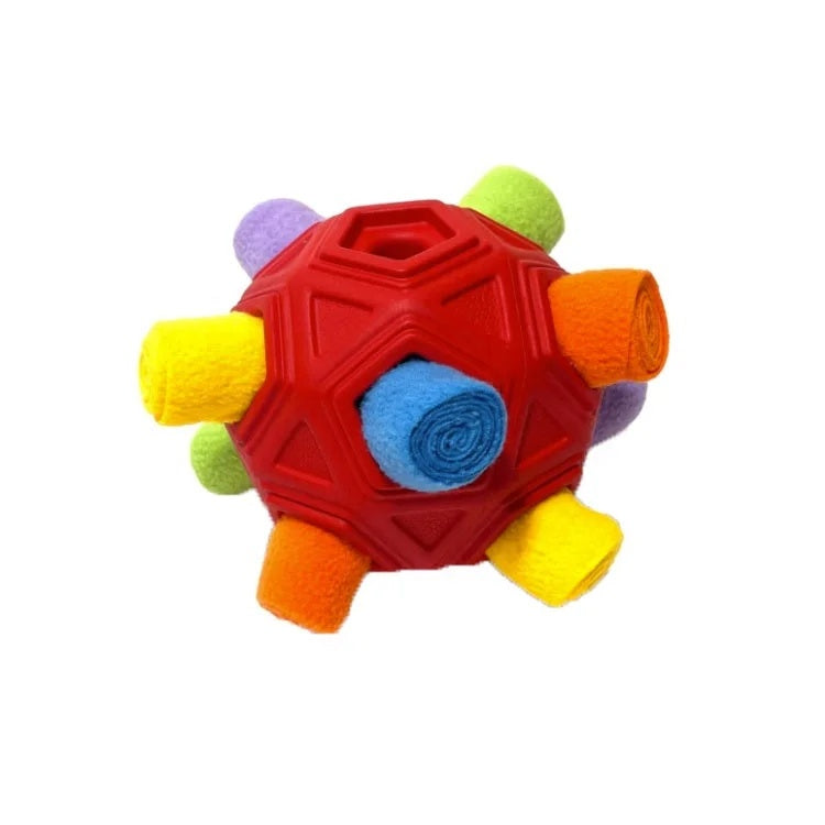 Red geometric TPR dog toy ball with colorful fleece rolls inserted for interactive puzzle play.