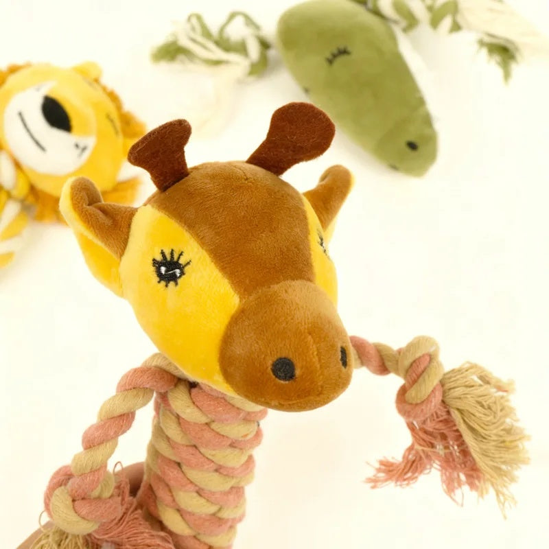 Close-up of a plush giraffe dog rope toy with braided cotton limbs and embroidered facial details.