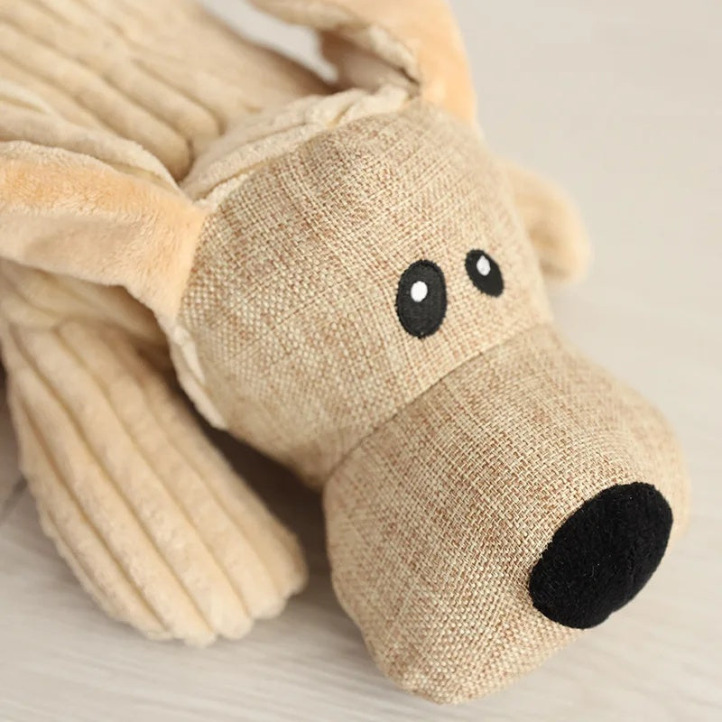 Close-up of the textured linen face and embroidered eyes of the cute dog plush toy.
