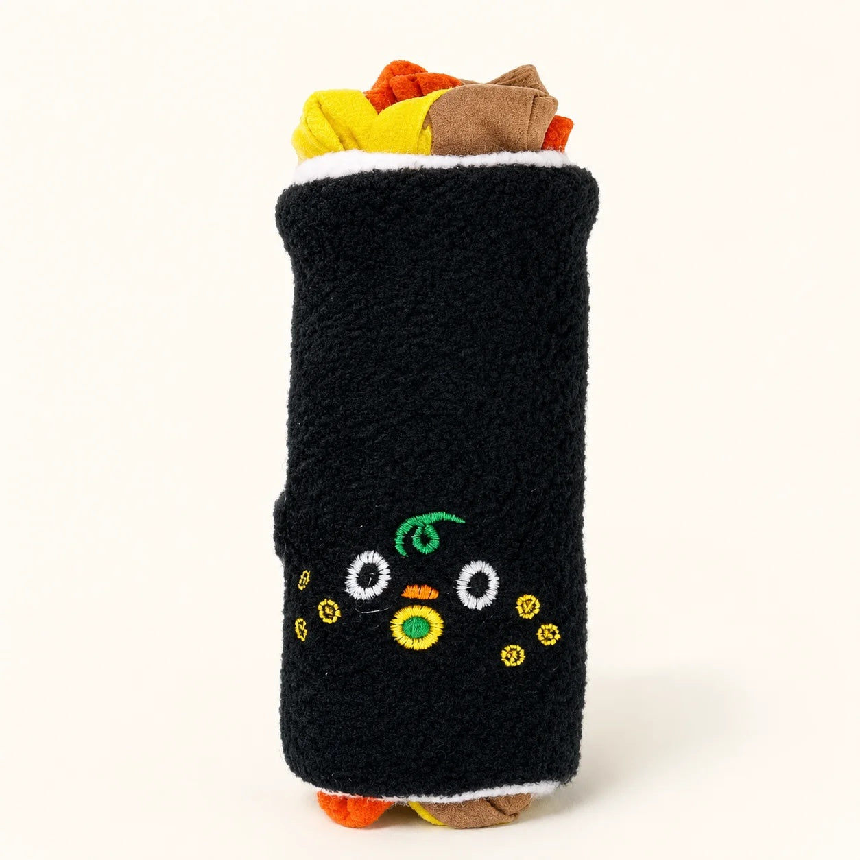 Close-up of the plush seaweed sushi dog toy showing an adorable embroidered cartoon face and colorful felt fillings.