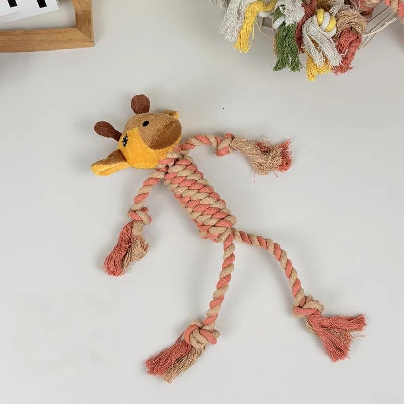 Cute yellow and pink giraffe squeaky dog toy made of braided cotton rope, laid flat on a white background.