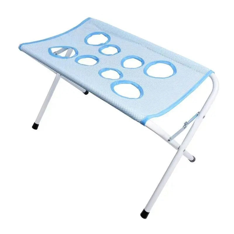 Blue mesh pet grooming hammock on a white metal stand with illustration of dog resting in it safely.