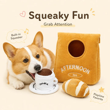Happy Corgi chewing on a plush coffee cup toy next to an Afternoon Tea snuffle bag and croissant toy.
