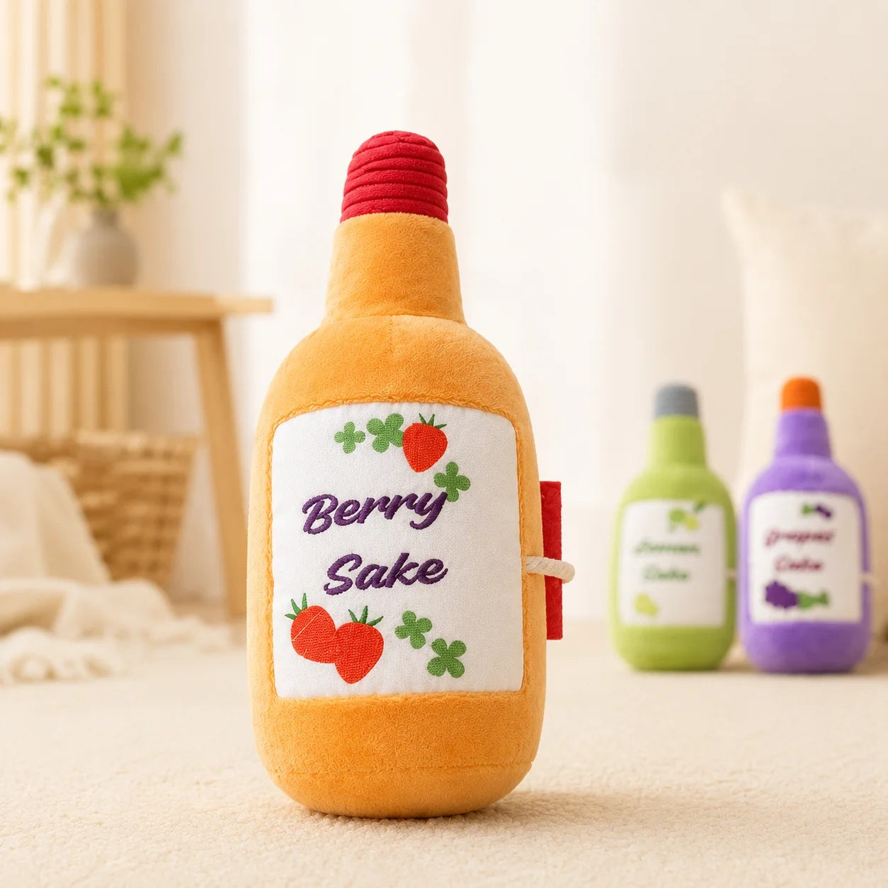Close-up of an orange Berry Sake plush interactive dog toy with cute strawberry graphics standing on a soft rug.