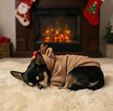 Sleeping small dog curled up by a fireplace wearing cozy Reindeer Fleece pajamas for Chihuahuas.